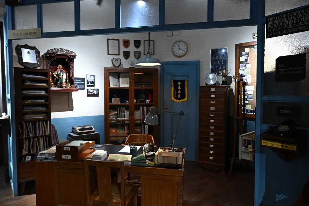 CID office, inspired by the duty officer’s desk setup of the 1970s and 1980s, featuring a Guan Gong (top left) that introduces visitors to the tradition of worshipping Guan Gong in Hong Kong police stations.